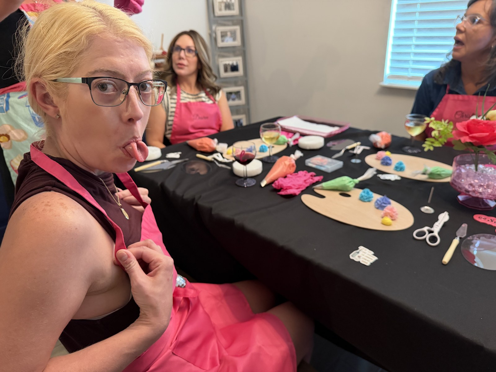 Sweet Intentions decorating workshop — pink aprons, frosting, wine